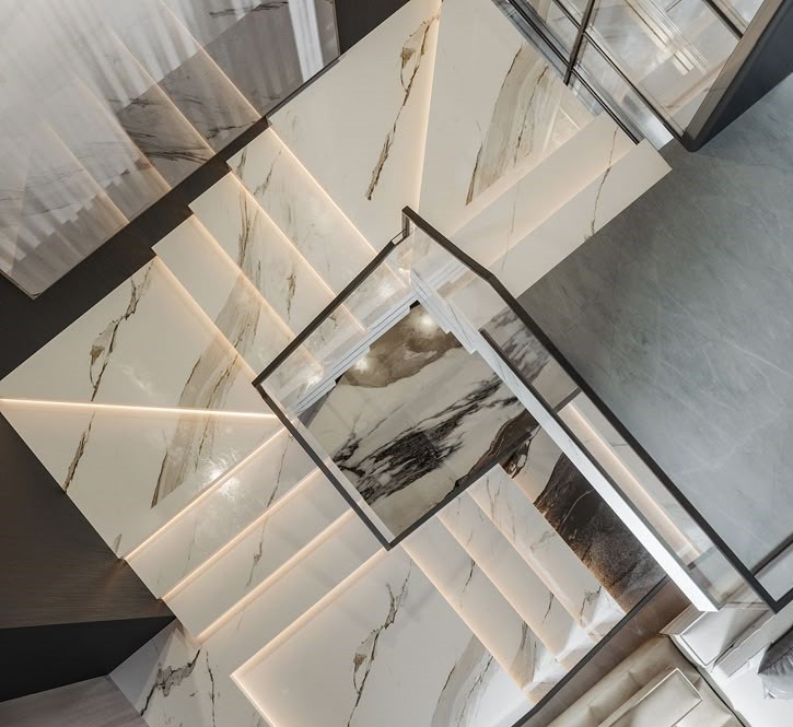 A grand entrance hall with polished marble flooring.