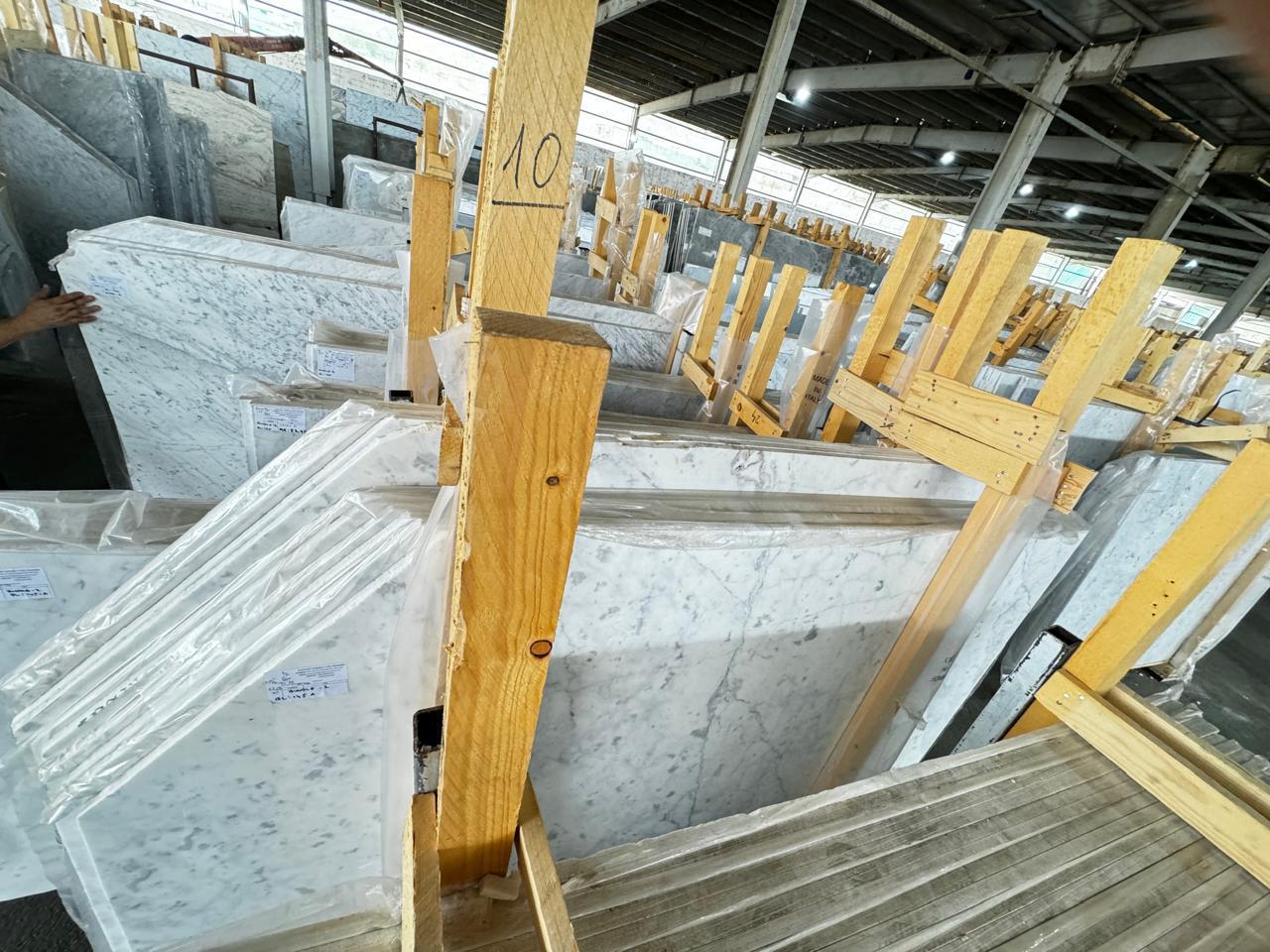 A large industrial machine cutting a slab of granite with high precision.